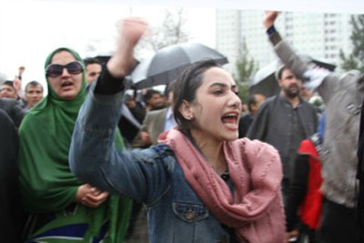Na manifestação contra o assassinato de Farkhunda a 23 de Março em Cabul, uma mulher retira o véu em protesto